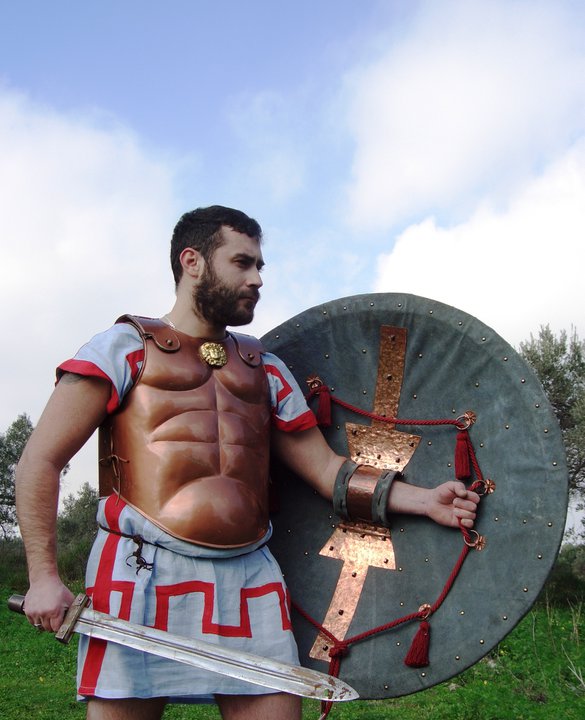 Ανακατασκευή του Συγγραφέα ξύλινης Οπλιτικής ασπίδας. Η ασπίδα έχει διάμετρο 97 πόντους, ζυγίζει 6 κιλά και διαθέτει σύστημα ιμάντων ανάρτησης 8 σημείων. Το εσωτερικό έχει καλυφθεί εξ’ολοκλήρου με δέρμα. Αυτό που ξεχωρίζει είναι ο αποσπώμενος επενδεδυμένος με δέρμα πόρπακας, μία έξυπνη κατασκευαστική προσέγγιση που εφάρμοζε ο Σπαρτιατικός στρατός υπό τον φόβο της αδιάλειπτης απειλής των Ειλώτων. Στην πράξη, η απόσπαση του πόρπακα από τον νόμιμο ιδιοκτήτη της ασπίδας, εξουδετερώνει την όποια χρηστικότητά της από κάποιον επίδοξο σφετεριστή (του Είλωτα, στην προκειμένη περίπτωση). Ο πόρπακας στην εν λόγω ασπίδα ασφαλίζει και απασφαλίζει με την βοήθεια δύο μεταλλικών ευθυτενών ελασμάτων, προσφέροντας μέγιστη δυνατή στήριξη και εργονομία. Image may be copyrigthed.